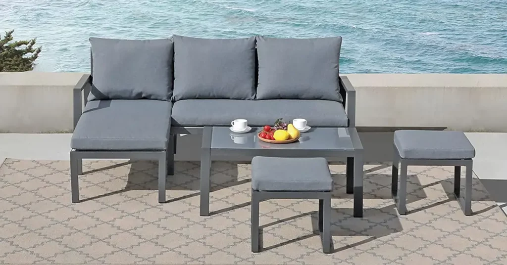 A grey outdoor set with a sofa, table and two ottomans - cost of patio furniture sets